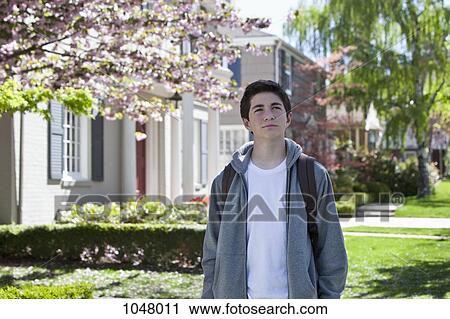 Boy standing still outside and looking up View Large Photo Image Stock Image - Boy standing still outside and looking up. Fotosearch