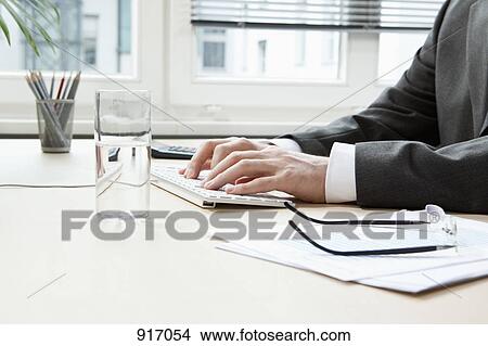 Picture - Businessman hands typing. Fotosearch