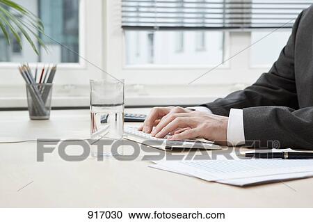 Stock Image - Businessman hands typing. Fotosearch