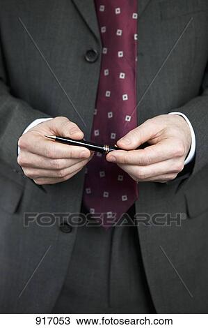 Businessman holding pen close up View Large Photo Image Stock Image - Businessman holding pen close up. Fotosearch