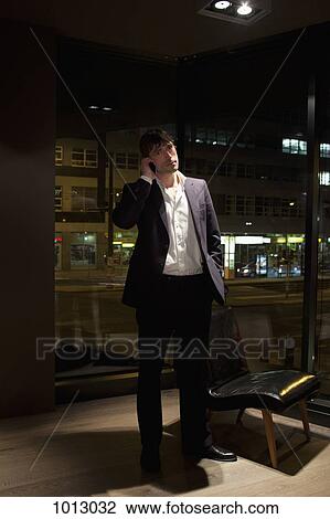 Businessman standing up on the phone with hand in his pocket. View Large Photo Image Stock Image - Businessman standing up on the phone with hand in his pocket.. Fotosearch