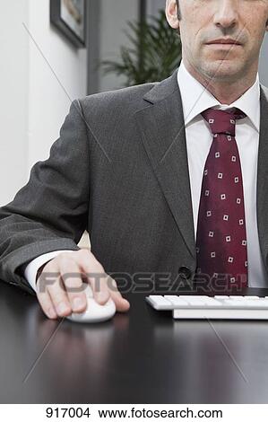 Businessman with mouse View Large Photo Image Picture - Businessman with mouse. Fotosearch