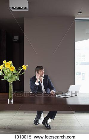 Businessman works at home and is on the phone. View Large Photo Image Stock Photography - Businessman works at home and is on the phone.. Fotosearch