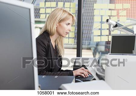Businesswoman typing in the office View Large Photo Image Stock Image - Businesswoman typing in the office. Fotosearch