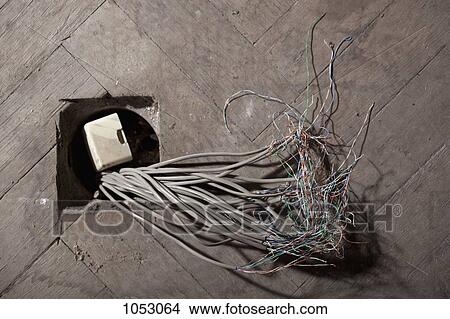 Cables coming out of a hole in a floor View Large Photo Image Picture - Cables coming out of a hole in a floor. Fotosearch