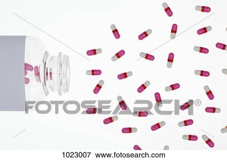 Capsules spilling from a pill bottle View Large Photo Image Stock Photo - Capsules spilling from a pill bottle. Fotosearch