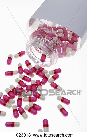 Stock Photo - Capsules spilling from a pill bottle. Fotosearch