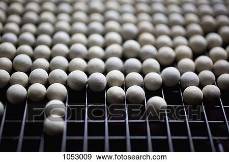 Ceramic pie weights lined up on a metal rack View Large Photo Image Stock Photo - Ceramic pie weights lined up on a metal rack. Fotosearch