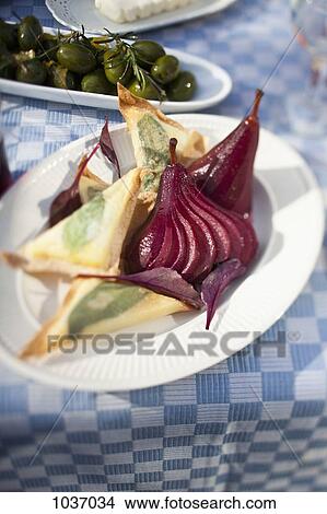Cheese toast triangles and sliced pickled pears on a paper plate with green olives in the background View Large Photo Image Picture - Cheese toast triangles and sliced pickled pears on a paper plate with green olives in the background. Fotosearch