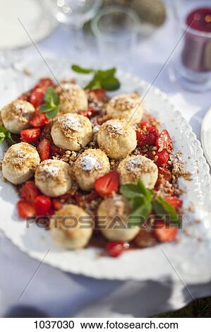 Choux pastry and chopped strawberries on a serving dish on table outside View Large Photo Image Stock Image - Choux pastry and chopped strawberries on a serving dish on table outside. Fotosearch