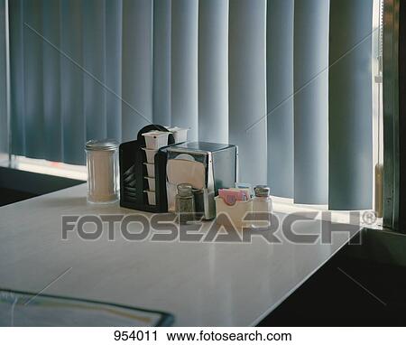 Stock Image - Condiments on a diner table. Fotosearch