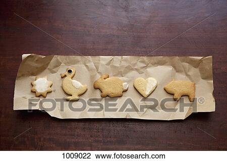 Cookies arranged in a row on brown paper View Large Photo Image Stock Image - Cookies arranged in a row on brown paper. Fotosearch