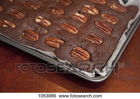 Stock Photograph - Detail of a baked cake in a tray. Fotosearch