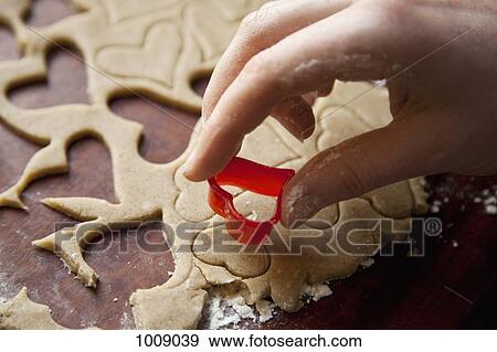 Detail of a hand using a heart shape cookie cutter View Large Photo Image Stock Photo - Detail of a hand using a heart shape cookie cutter. Fotosearch