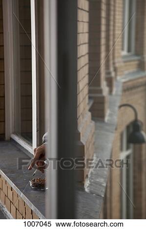 Detail of a person smoking out a window View Large Photo Image Stock Photography - Detail of a person smoking out a window. Fotosearch