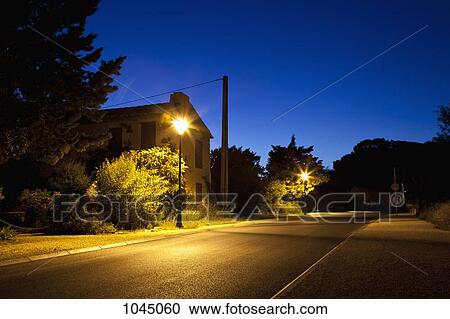 Stock Image - Detail of a residential street at dusk. Fotosearch