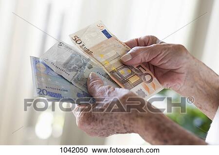 Detail of a senior woman holding European banknotes View Large Photo Image Stock Image - Detail of a senior woman holding European banknotes. Fotosearch