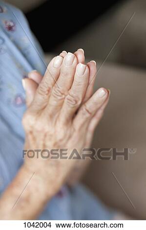 Detail of a senior woman praying View Large Photo Image Picture - Detail of a senior woman praying. Fotosearch