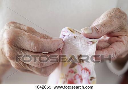 Detail of a senior woman stitching fabric View Large Photo Image Stock Photography - Detail of a senior woman stitching fabric. Fotosearch