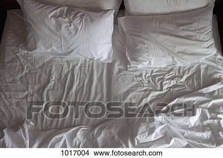 Detail of an unmade double bed View Large Photo Image Picture - Detail of an unmade double bed. Fotosearch
