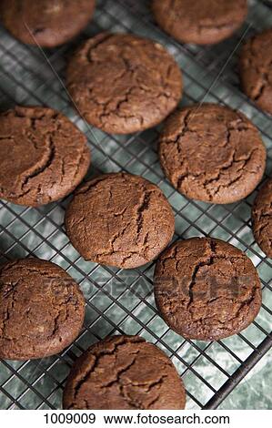 Detail of chocolate cookies on a rack View Large Photo Image Stock Photo - Detail of chocolate cookies on a rack. Fotosearch