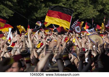 Detail of people in a crowd waving German flags View Large Photo Image Picture - Detail of people in a crowd waving German flags. Fotosearch