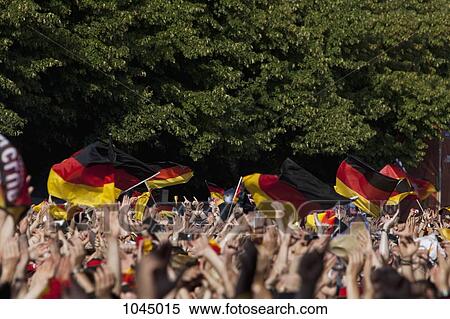 Detail of people in a crowd waving German flags View Large Photo Image Stock Photography - Detail of people in a crowd waving German flags. Fotosearch