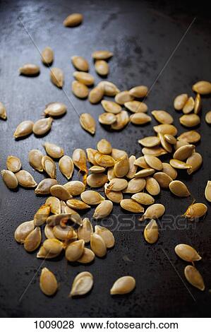 Detail of pumpkin seeds in a pan View Large Photo Image Stock Photo - Detail of pumpkin seeds in a pan. Fotosearch
