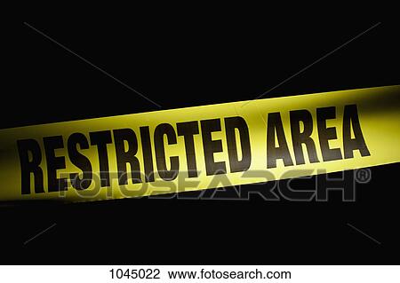 Stock Image - Detail of RESTRICTED AREA cordon tape. Fotosearch