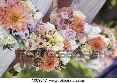 Detail of women holding bouquets of flowers View Large Photo Image Stock Photo - Detail of women holding bouquets of flowers. Fotosearch