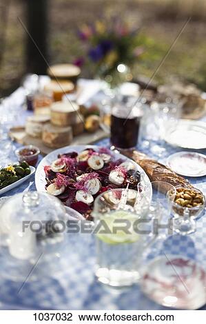 Dining table outside with focus on a dish of goat's cheese and pickled pears View Large Photo Image Stock Image - Dining table outside with focus on a dish of goat's cheese and pickled pears. Fotosearch
