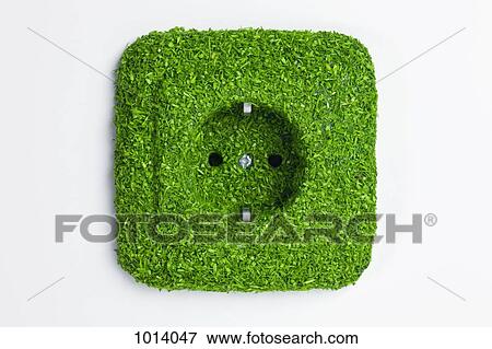 Stock Photo - Energy saving electrical wall outlet covered in green grass. Fotosearch