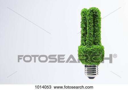 Energy saving light bulb covered in green grass. View Large Photo Image Stock Image - Energy saving light bulb covered in green grass. . Fotosearch