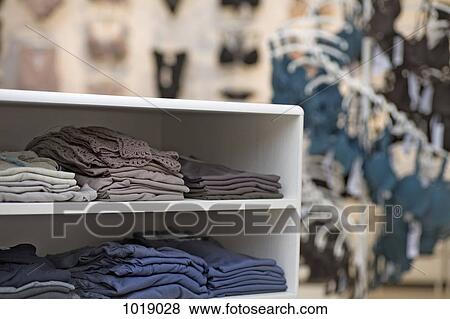 Folded t-shirts in a clothing store View Large Photo Image Stock Photo - Folded t-shirts in a clothing store. Fotosearch