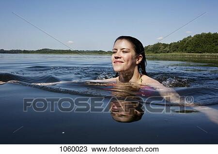 Girl happily swimming in lake View Large Photo Image Stock Image - Girl happily swimming in lake. Fotosearch