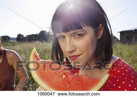 Girl has slice of melon in her hand with bike marks on it View Large Photo Image Stock Photo - Girl has slice of melon in her hand with bike marks on it. Fotosearch