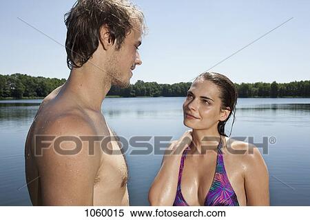 Girlfriend and boyfriend making eye contact beside the lake View Large Photo Image Stock Photography - Girlfriend and boyfriend making eye contact beside the lake. Fotosearch