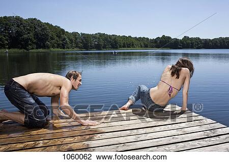 Girlfriend and boyfriend on jetty playing View Large Photo Image Stock Image - Girlfriend and boyfriend on jetty playing. Fotosearch