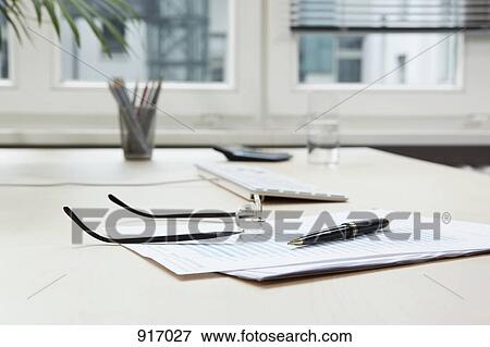 Glasses on desk & office equipment View Large Photo Image Stock Photo - Glasses on desk & office equipment. Fotosearch