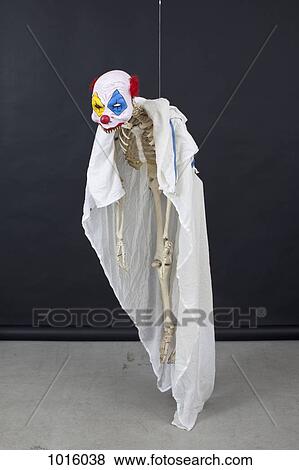 Hanging skeleton with clown mask. View Large Illustration Stock Illustration - Hanging skeleton with clown mask.. Fotosearch