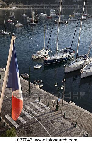 Harbor with French flag in the foreground View Large Photo Image Stock Image - Harbor with French flag in the foreground. Fotosearch
