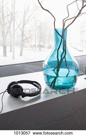 Headphones and vase with twigs on window sill. View Large Photo Image Stock Photo - Headphones and vase with twigs on window sill.. Fotosearch