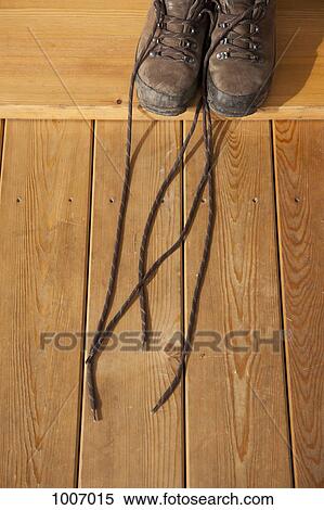 Hiking boots on a hardwood floor View Large Photo Image Stock Photography - Hiking boots on a hardwood floor. Fotosearch