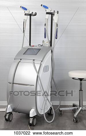 Stock Image - Large ultrasound equipment beside a stool in a hospital. Fotosearch