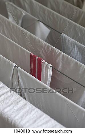 Laundry drying on a drying rack View Large Photo Image Stock Photo - Laundry drying on a drying rack. Fotosearch