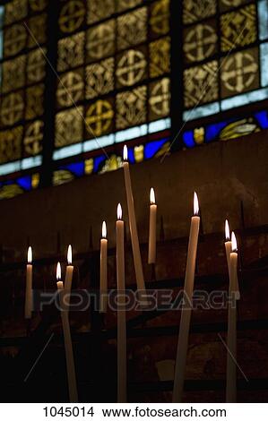 Picture - Lit candles in a church. Fotosearch