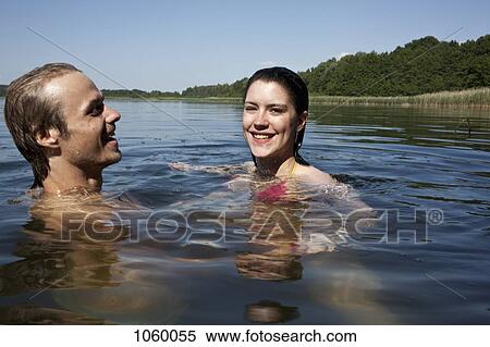 Man and woman happily swimming in lake View Large Photo Image Stock Photography - Man and woman happily swimming in lake. Fotosearch