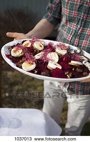 Man holding a serving dish of goat's cheese View Large Photo Image Stock Image - Man holding a serving dish of goat's cheese. Fotosearch