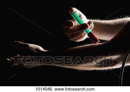 Man taking a blood sample from his arm View Large Photo Image Stock Photograph - Man taking a blood sample from his arm. Fotosearch