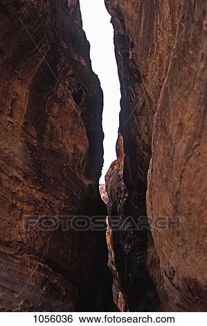Middle east, Jordan, Petra, view through a natural narrow canyon View Large Photo Image Stock Photograph - Middle east, Jordan, Petra, view through a natural narrow canyon. Fotosearch